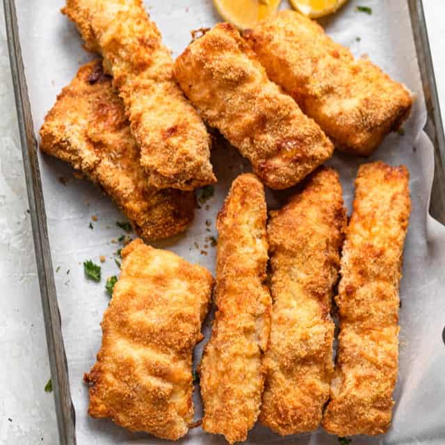 A baking sheet with pieces of air fried cod.