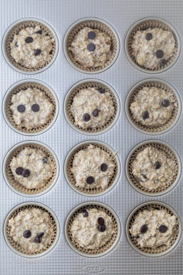 Banana oatmeal cup mixture in a muffin tin before baking.