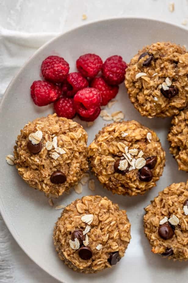 Muffin cups on a plate with fresh raspberies