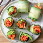 Cucumber roll sushi on a serving dish with chopsticks.