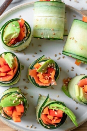 Cucumber roll sushi on a serving dish with chopsticks.
