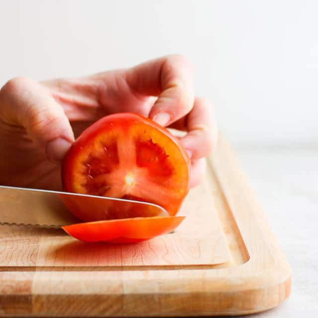 A knife cutting down in parallel slices.