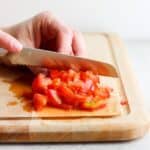 Diced tomatoes on a cutting board.