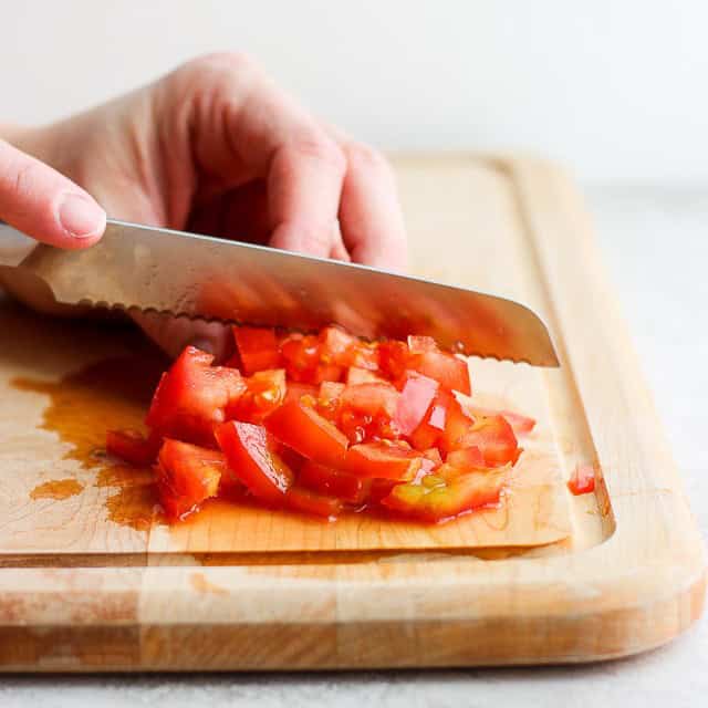 Diced tomatoes on a cutting board.