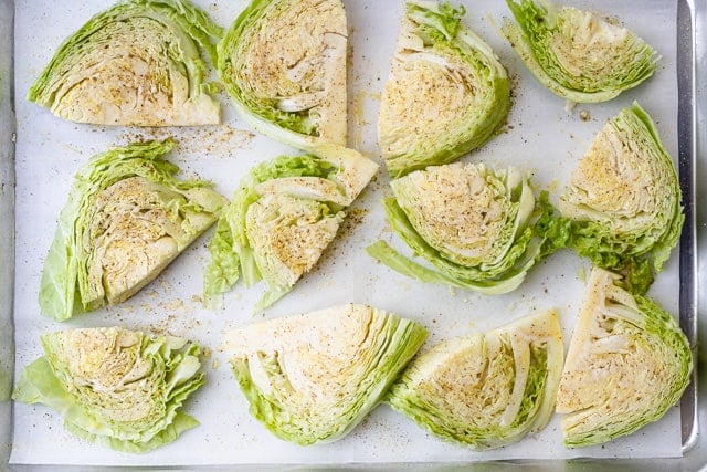 The uncooked cabbage on a baking sheet