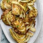 Roasted cabbage slices on a white plate
