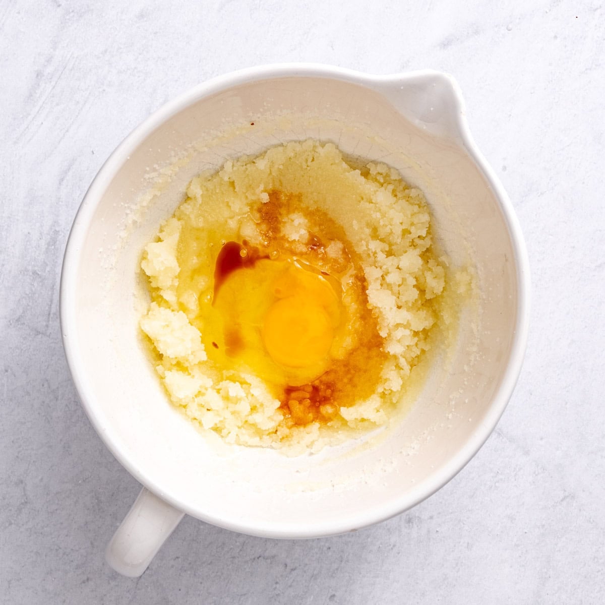 After whisking until the sugar is fully combined, with egg and vanilla added before combining.