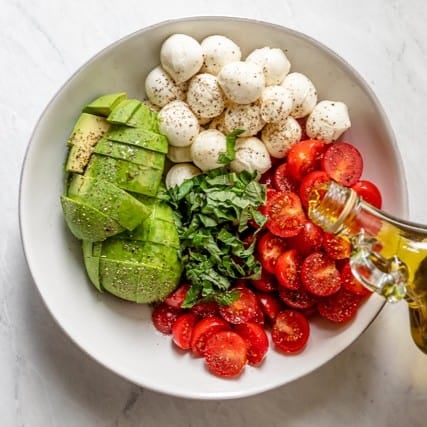 Olive oil being poured into the bowl.