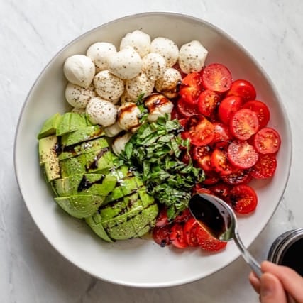 Balsamic being poured into the bowl.