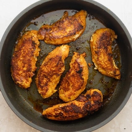 Chicken in a skillet after cooking.