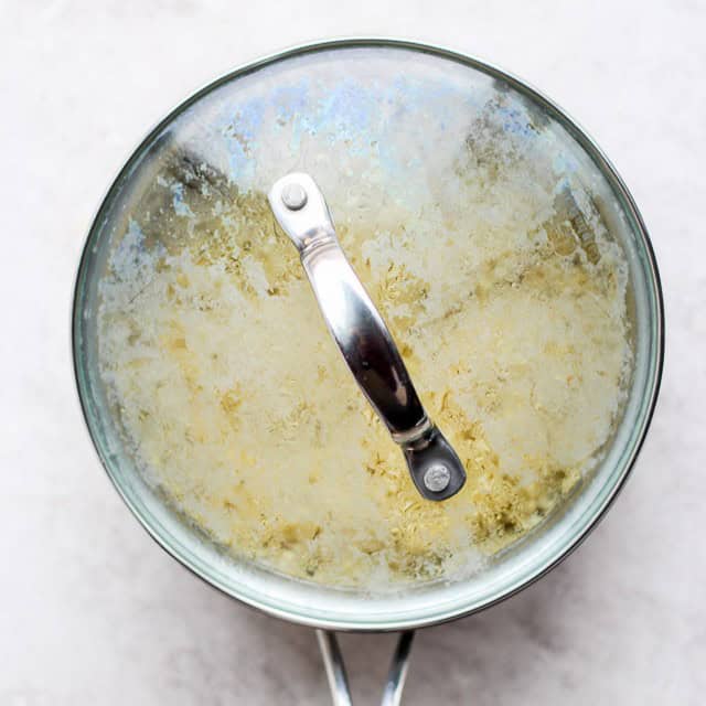Quinoa in a pot that is covered.