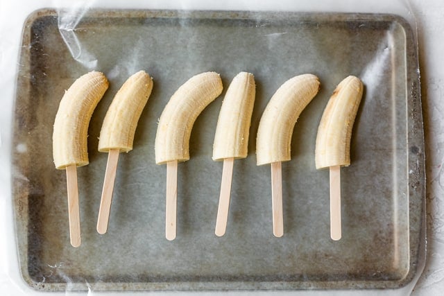 Banana halves on popsicle sticks