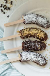 Chocolate covered bananas with toppings