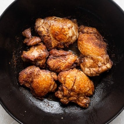 Chicken cooked in a pan.