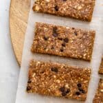 Close up shot of three vegan protein bars on parchment paper