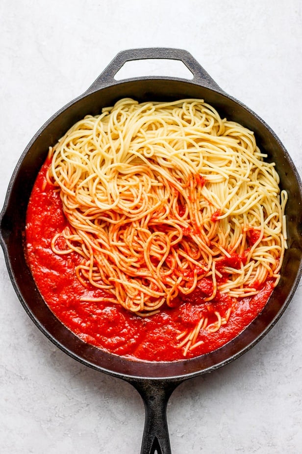 overhead shot of cooking pasta in a skillet with sauce