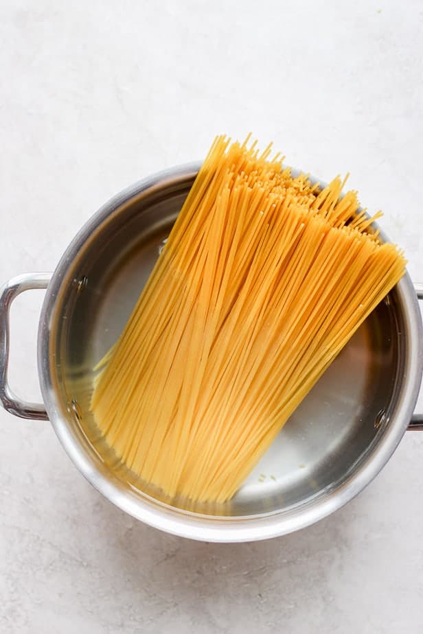 dried spaghetti in a pot with water