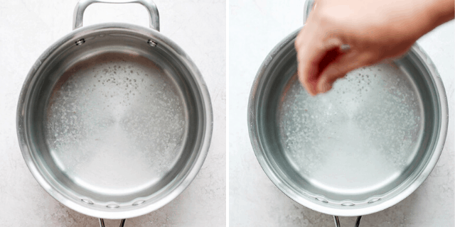 hand adding salt to water in a pot