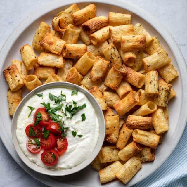 Large plate of pasta chips served with whipped feta dip