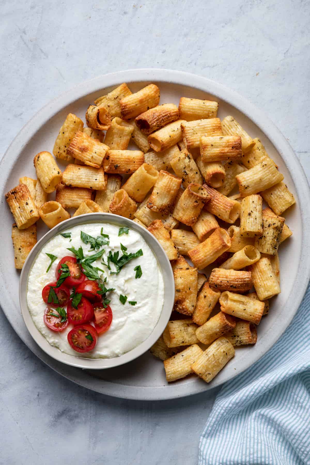 Large plate of pasta chips served with whipped feta dip