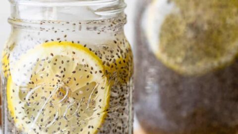 Two large mason jars filled with chia fresca and round lemon slices