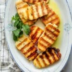Grilled halloumi on platter with mint and olive oil