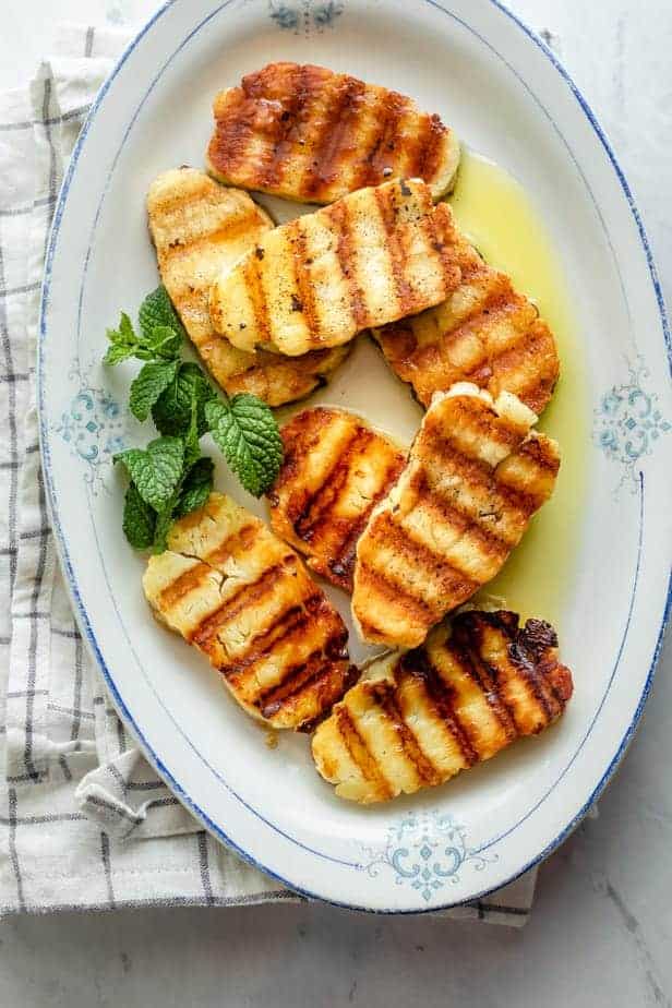 Grilled halloumi on platter with mint and olive oil