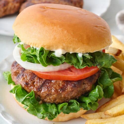 Homemade hamburger on a bun with toppings.