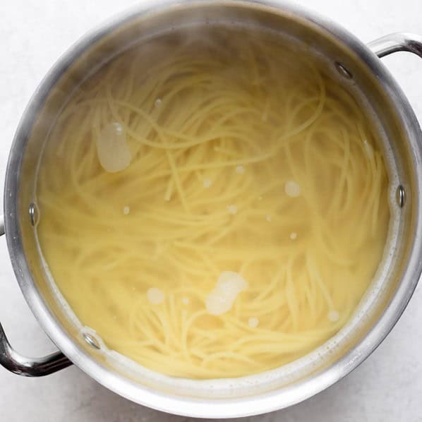 Spaghetti in a pot of water.