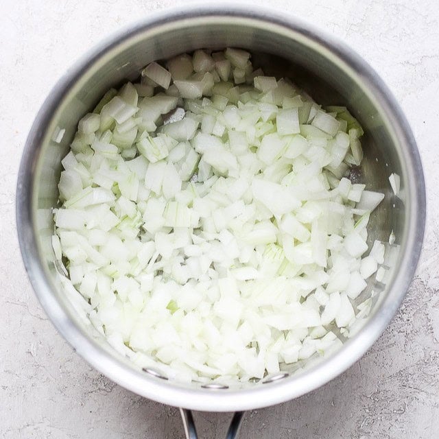Cut onions in pot.