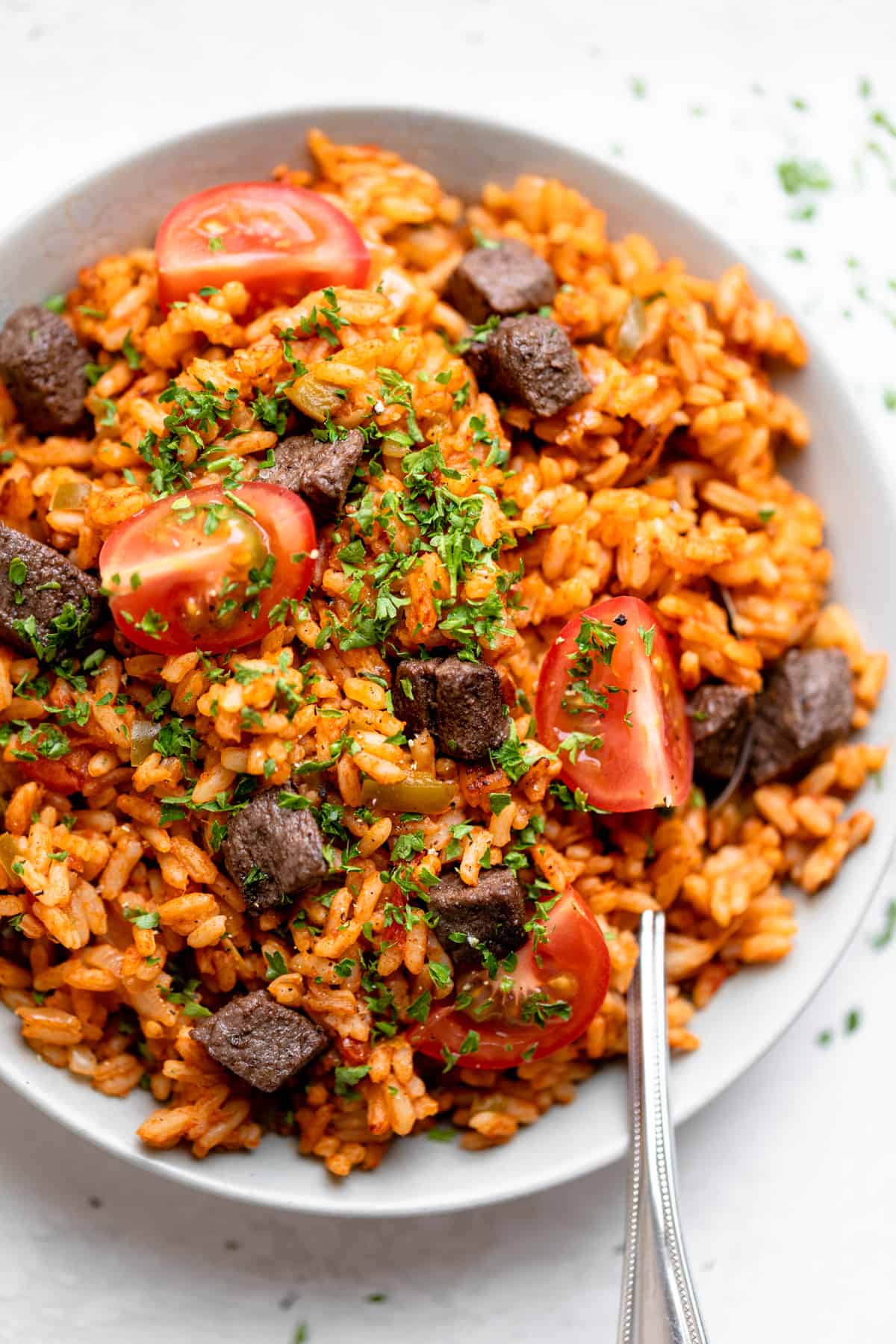 Spoon in bowl of Nigerian jollof rice