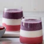 Berry layered smoothie with pink, white and purple layers