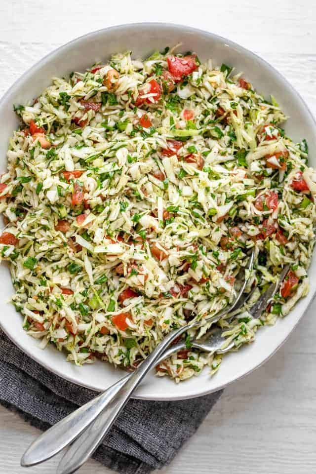 Large bowl of Lebanese cabbage salad with tomatoes and cilantro
