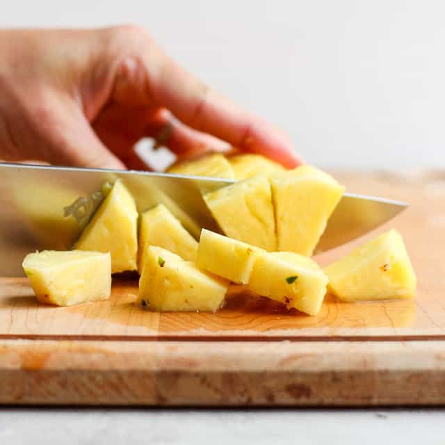 Cutting pineapple in chunks