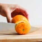 Cutting to top off an orange