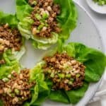Round plate with four butter lettuce pieces topped with the ground beef mixture