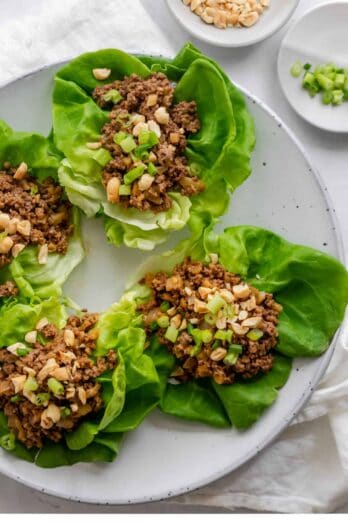 Round plate with four butter lettuce pieces topped with the ground beef mixture
