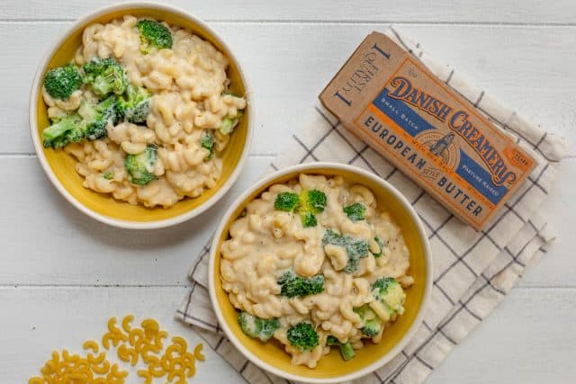 Two bowls of broccoli mac and cheese made with Danish creamery butter - pictured next to the bowls