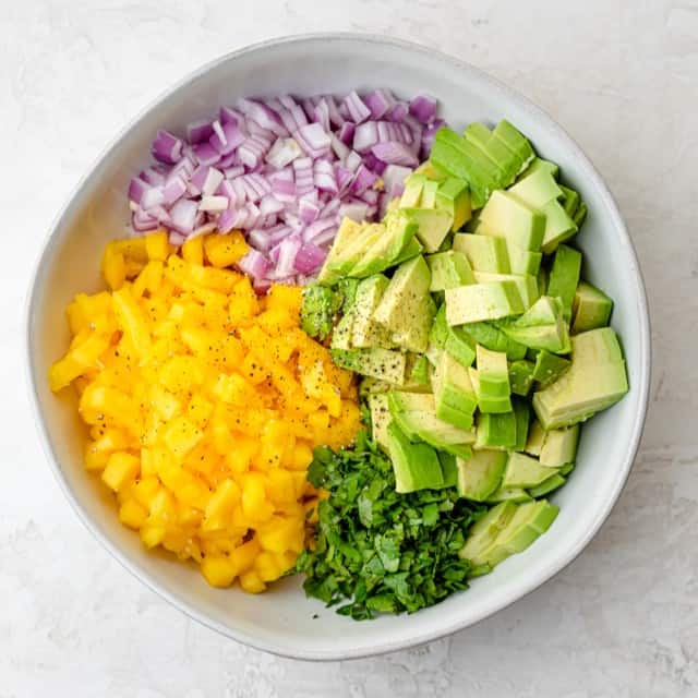 Salsa ingredients in a bowl before combining.