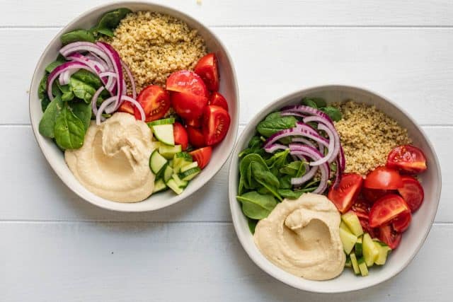 Building the mediterranean hummus bowls with veggies