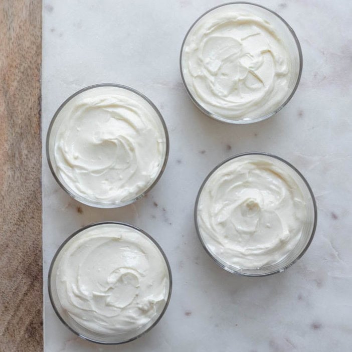Cheesecake filling added to the cups.