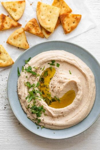 Plate of white bean hummus garnished with parsley