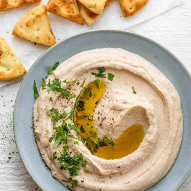 Plate of white bean hummus garnished with parsley