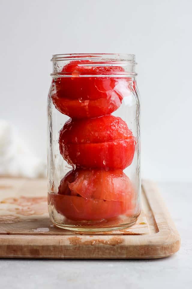 Tomatoes piled in glass mason jar