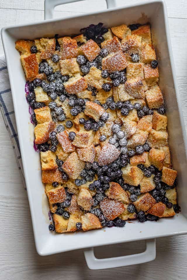 Blueberry French toast casserole after getting dusted with powdered sugar in a large casserole dish