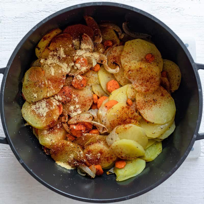 Vegetables added to a pot.
