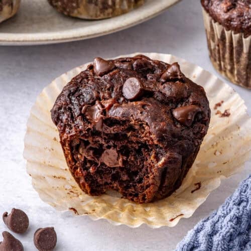 Close shot of one muffin with a bite taken.
