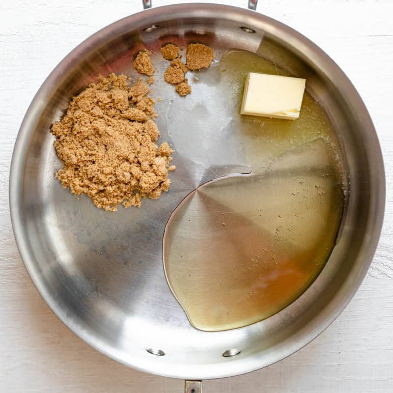 Honey, butter and brown sugar in a pot before melting.