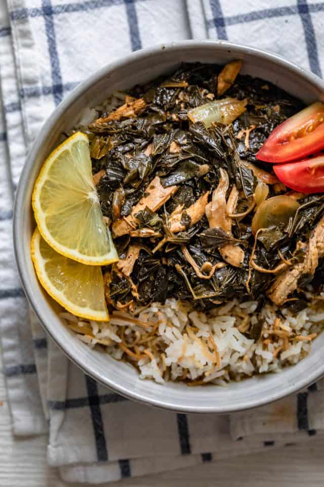 Bowl of mlukhiyeh served over Lebanese rice