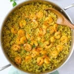 Shrimp and rice in the pot after fluffing rice, garnished with chopped parsley.